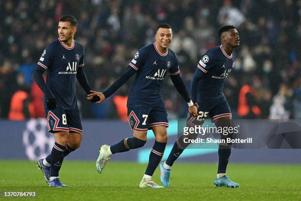 Kylian Mbappe celebrates with Leandro Paredes and Nuno Mendes of Paris Saint-Germain after scoring their team's first goal during the UEFA Champions...