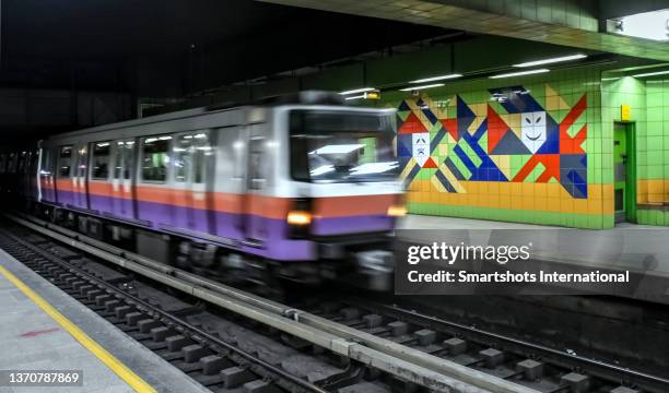 blurred metro train entering a station decorated with egyptian-style murals in cairo, egypt - underground sign stock pictures, royalty-free photos & images