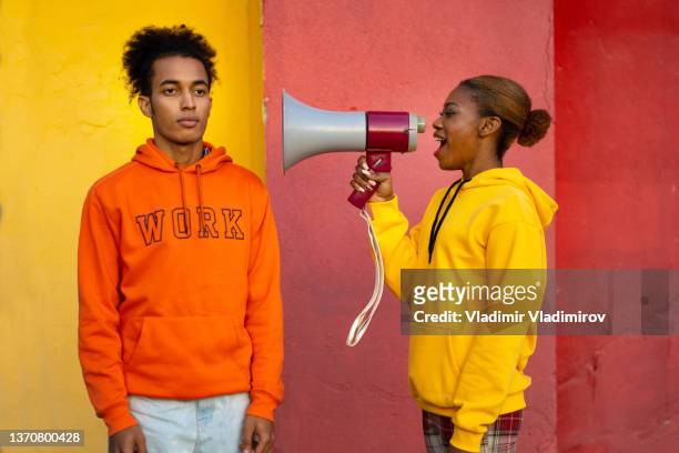 a female protestors shouting in a the megaphone at a man - couple placard stock pictures, royalty-free photos & images