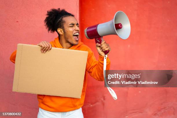 young man protesting with blank placard - change attitude stock pictures, royalty-free photos & images