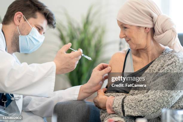 cancer patient receiving a vaccine - vaccine confidence stock pictures, royalty-free photos & images