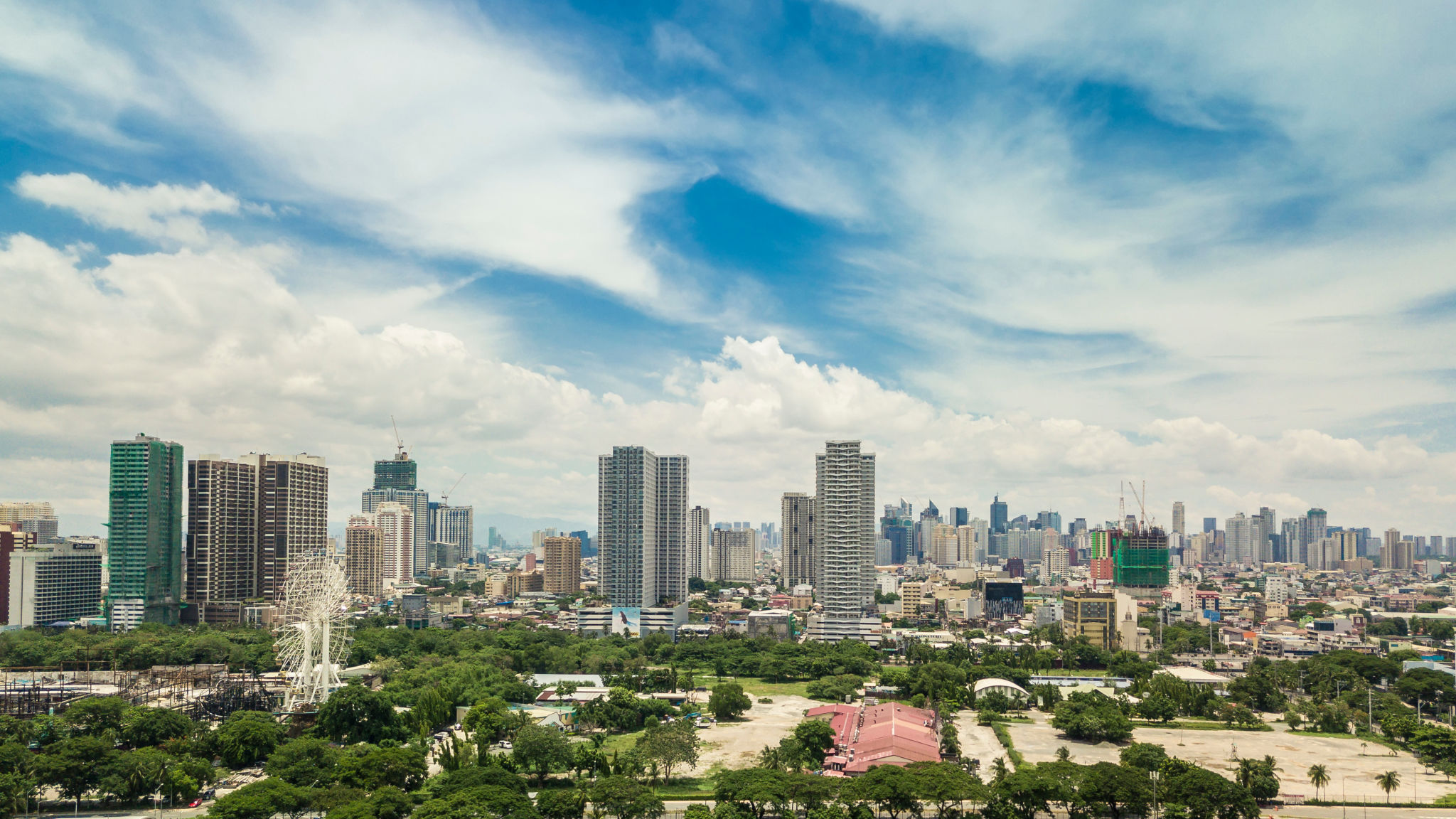 Manila, Philippines - Condominiums along Roxas Blvd. Makati City skyline at the background. Manila, Philippines - Condominiums along Roxas Blvd. Makati City skyline at the background.