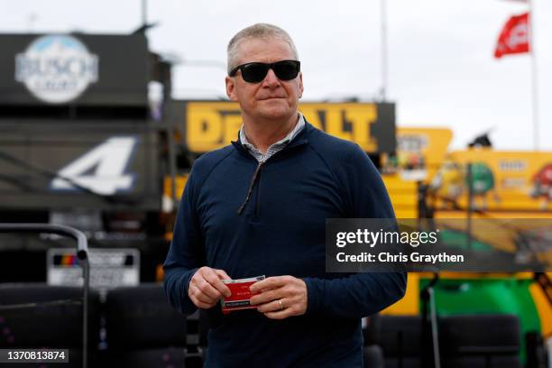 Hall of Famer Jeff Burton walks through the garage area during practice for the NASCAR Cup Series 64th Annual Daytona 500 at Daytona International...