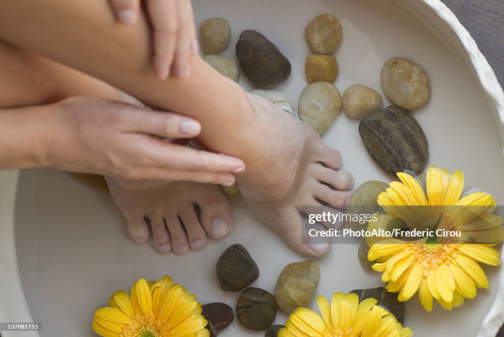 Woman enjoying relaxing foot bath