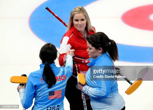 Jennifer Jones of Team Canada is congratulated by Tabitha Peterson and Becca Hamilton of Team United States during the Women's Round Robin Session on...