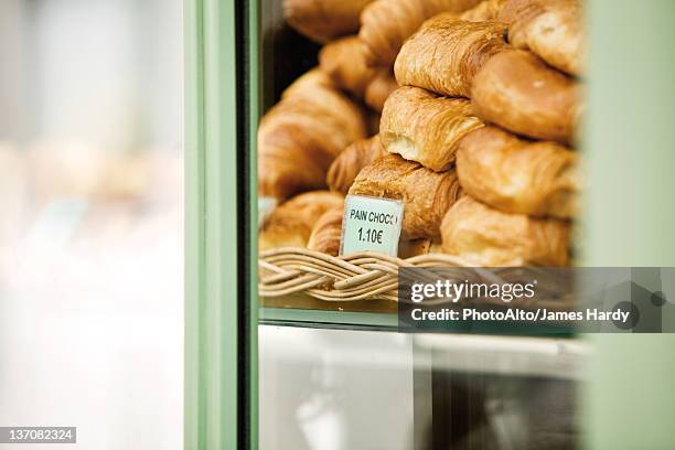 pastries in bakery display - pain au chocolat stock-fotos und bilder