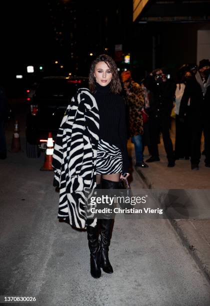Mary Leest seen wearing skirt and coat with zebra print, over knee boots outside Michael Kors during New York Fashion Week on February 15, 2022 in...