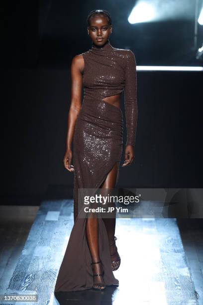 Adut Akech walks the runway during Michael Kors Collection Fall/Winter 2022 Runway Show at Terminal 5 on February 15, 2022 in New York City.
