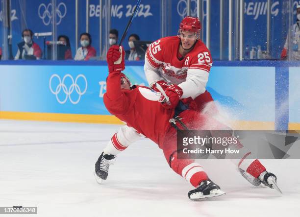 Oliver Lauridsen of Team Denmark checks Andrei Chibisov of Team ROC in the first period during the Men’s Ice Hockey Quarterfinal match between Team...