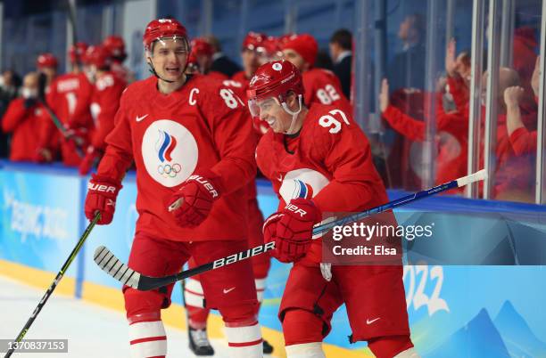 Vadim Shipachyov and Nikita Gusev of Team ROC react after celebrating Shipachyov's goal with teammates on the bench during the Men’s Ice Hockey...