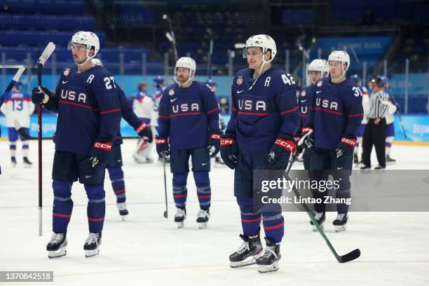 Noah Cates, Aaron Ness, Ben Meyers and their Team United States teammates look on dejected after their shootout loss in the Men’s Ice Hockey...