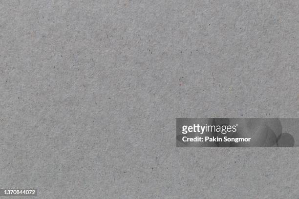 gray colored eco-recycled kraft paper sheet texture was used to create the background. - paperboard stockfoto's en -beelden