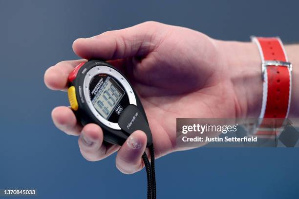 Valentin Tanner of Team Switzerland holds a stopwatch against Team China during the Men's Round Robin Session on Day 12 of the Beijing 2022 Winter...