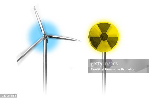 wind turbine along side with radiation warning symbol - nuclear energy stock illustrations