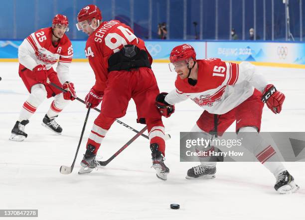 Kirill Semyonov of Team ROC makes a backhanded pass past Matias Lassen of Team Denmark in the third period during the Men’s Ice Hockey Quarterfinal...