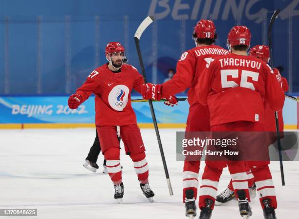 Vyacheslav Voinov of Team ROC celebrates with teammates after scoring a goal in the third period to lead 3-1 during the Men’s Ice Hockey Quarterfinal...
