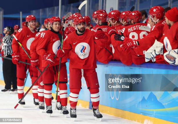 Vyacheslav Voinov of Team ROC reacts with teammates after scoring in the third period to lead 3-1 during the Men’s Ice Hockey Quarterfinal match...