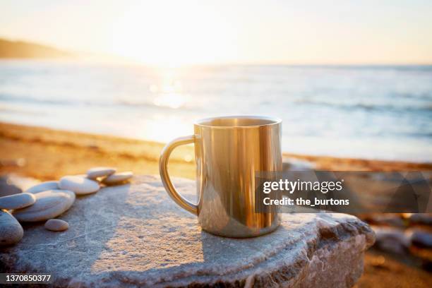 coffee mug at the sea against sunlight - sea cup stock pictures, royalty-free photos & images