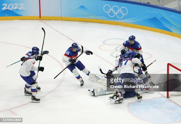 Team Slovakia celebrate with goaltender Patrik Rybar at their net after their shootout win during the Men’s Ice Hockey Quarterfinal match between...