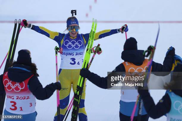 Elvira Oeberg of Team Sweden celebrates with team mates after winning gold during the Women's Biathlon 4x6km Relay on day 12 of 2022 Beijing Winter...