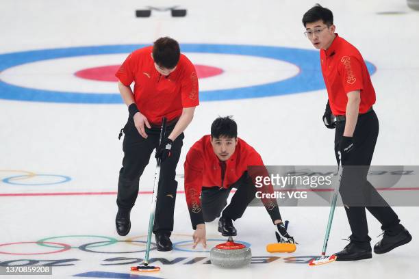 Wang Zhiyu, Zou Qiang and Xu Jingtao of Team China compete against Team Switzerland during the Men's Round Robin Session on Day 12 of the Beijing...