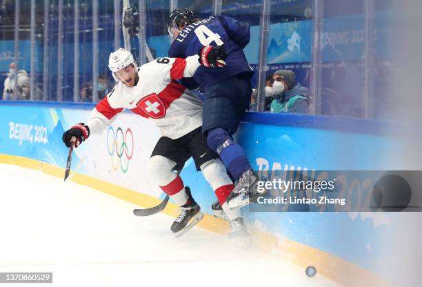 Mikko Lehtonen of Team Finland challenges Fabrice Herzog of Team Switzerland in the first period during the Men’s Ice Hockey Quarterfinal match...