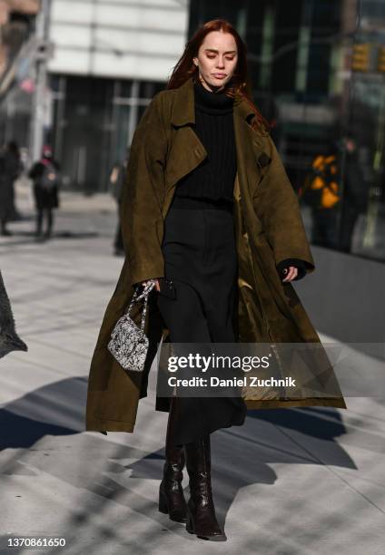 Tiernan Cowling is seen wearing a green coat, black sweater and black pants outside the Peter Do show during New York Fashion Week A/W 2022 on...