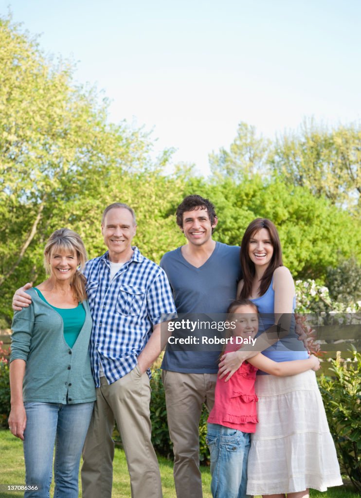 Portrait of smiling multi-generation family in backyard