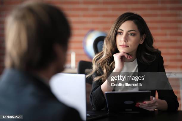 businesswoman interviewing male job candidate in the office meeting room - part of a series senior stock pictures, royalty-free photos & images