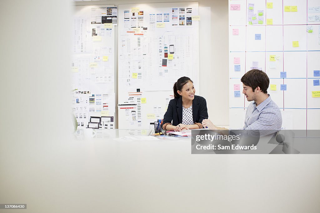 Businessman and businesswoman talking in meeting