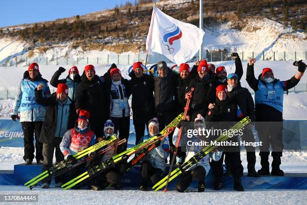 Silver medallists Irina Kazakevich, Svetlana Mironova, Kristina Reztsova and Uliana Nigmatullina of Team ROC pose with support staff during Women's...