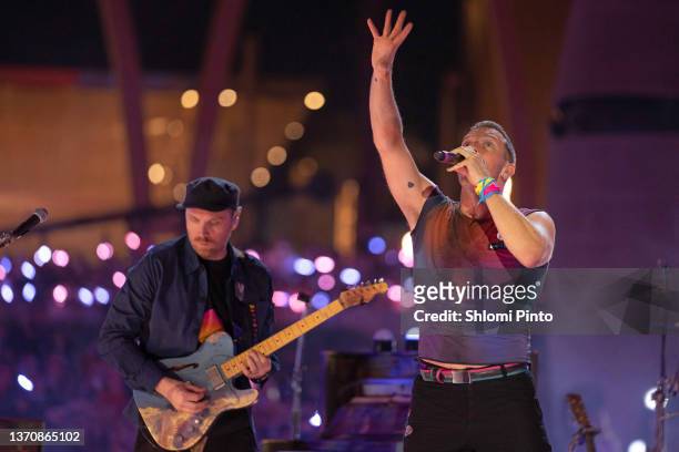 Jonny Buckland and Chris Martin of Coldplay perform live on stage at Al Wasl Plaza on February 15, 2022 in Dubai, United Arab Emirates.