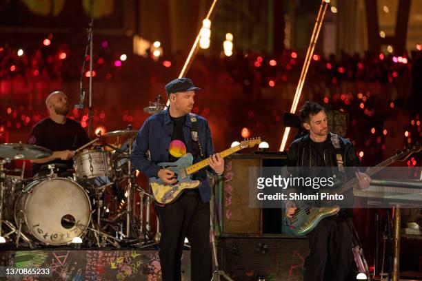 Will Champion, Chris Martin and Guy Berryman of Coldplay perform live on stage at Al Wasl Plaza on February 15, 2022 in Dubai, United Arab Emirates.
