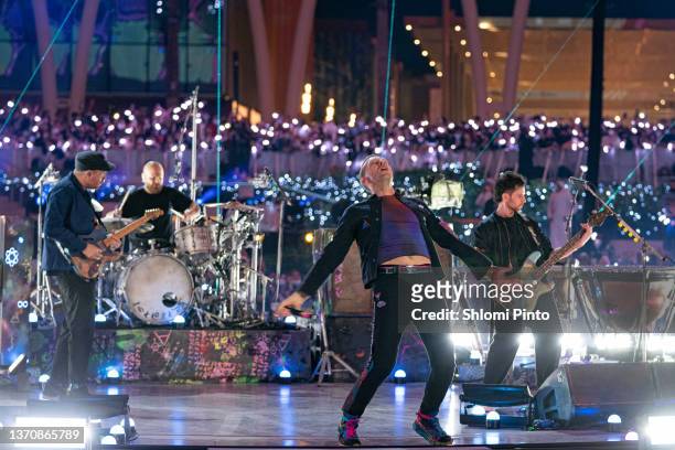Jonny Buckland, Will Champion, Chris Martin and Guy Berryman of Coldplay perform live on stage at Al Wasl Plaza on February 15, 2022 in Dubai, United...
