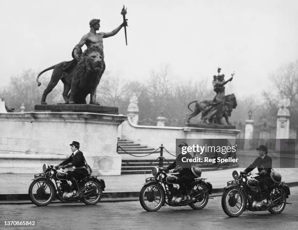 Wren despatch riders of the Women's Royal Naval Service attached to WRNS London Headquarters ride their Triumph 350CC 3SW motorcycles past the...