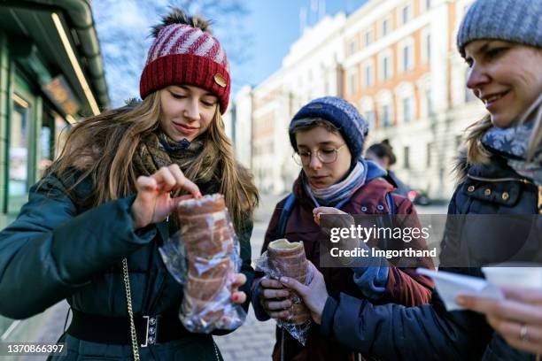 family sightseeing city on sunny but cold winter day. - krakow poland stock pictures, royalty-free photos & images