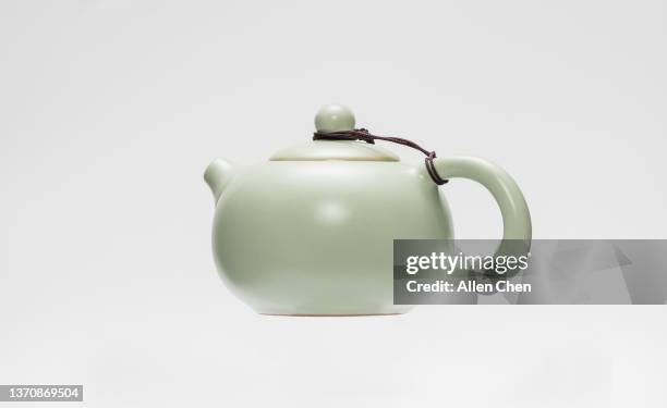 a ceramic teapot on a white background - théière photos et images de collection
