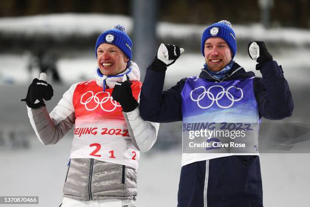 Silver medallists Iivo Niskanen and Joni Maki of Team Finland celebrate during Men's Team Sprint Classic flower ceremony on Day 12 of the Beijing...