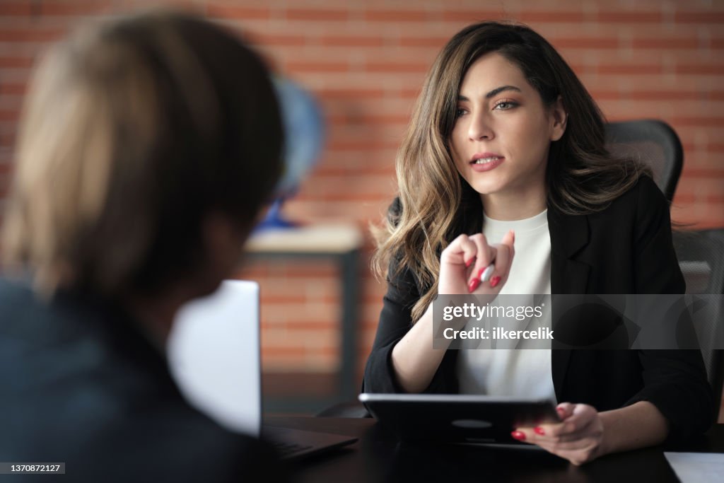 Businesswoman Interviewing Male Job candidate In The Office Meeting Room