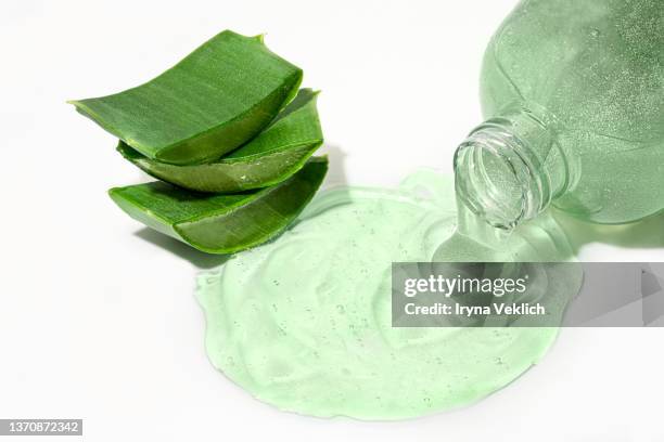 natural beauty product background with aloe vera slices and moisturizing cleaning cosmetic gel or face serum. - aloe vera gel stock-fotos und bilder