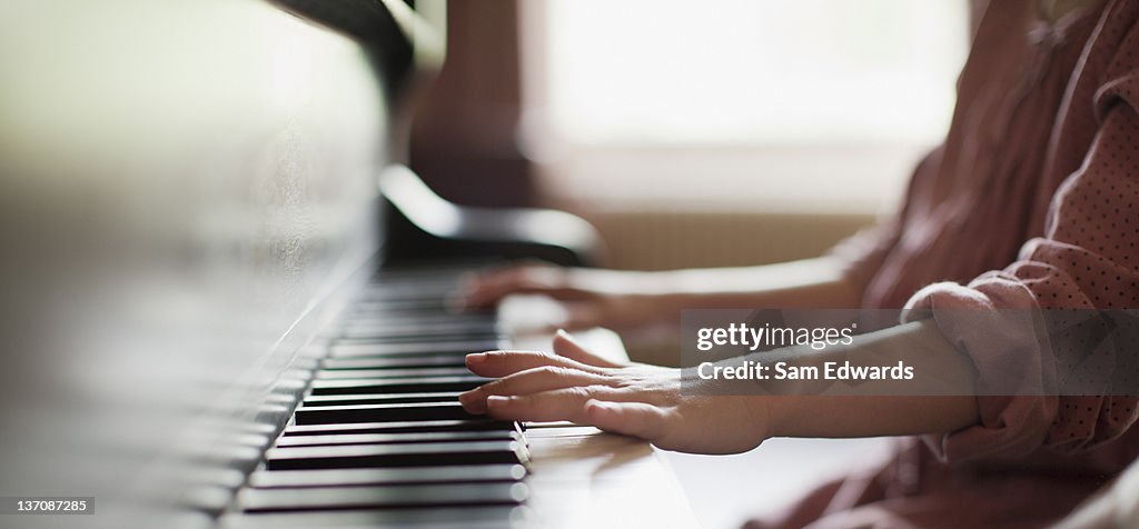 Close up of girl's hands on piano