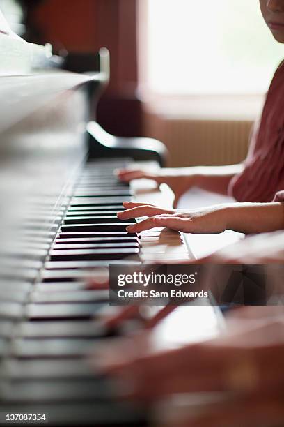 close up of hands on piano - piano stockfoto's en -beelden