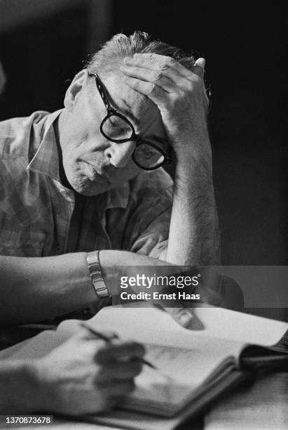 American ballet choreographer George Balanchine reads notes during a rehearsal, New York City, US, 1962.