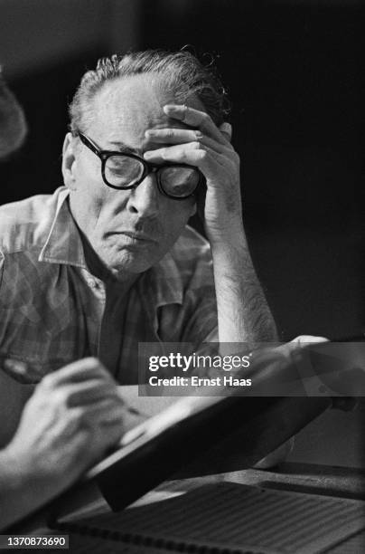 American ballet choreographer George Balanchine reads notes during a rehearsal, New York City, US, 1962.