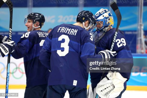 Harri Sateri, goaltender of Team Finland celebrate victory with team mate Niklas Friman after the third period during the Men’s Ice Hockey...