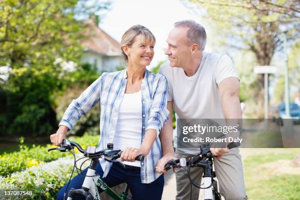 senior couple riding bicycles - couple cycling stock pictures, royalty-free photos & images