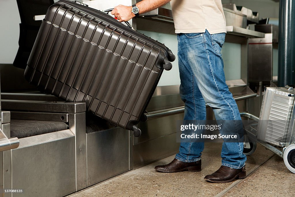 Man at check in desk of airport
