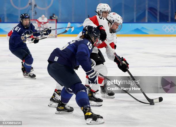 Minnamari Tuominen of Team Finland takes the puck from Alina Marti of Team Switzerland in the first period during the Women’s Ice Hockey Bronze medal...