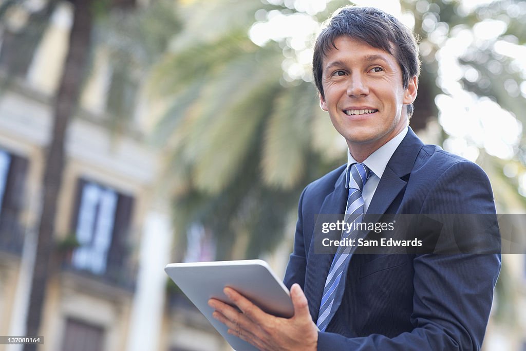 Businessman using digital tablet outdoors