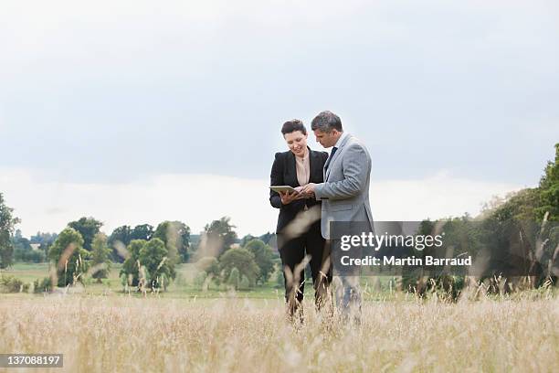 business people using digital tablet outdoors - outdoor business meeting stock pictures, royalty-free photos & images